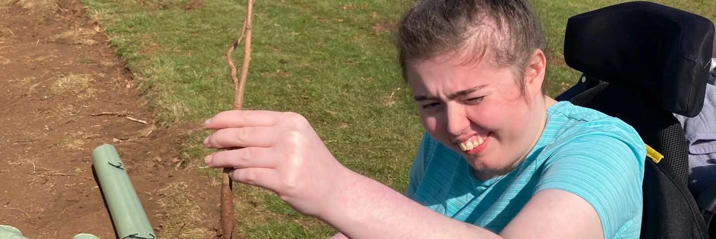 Ellie Lloyd planting sapling