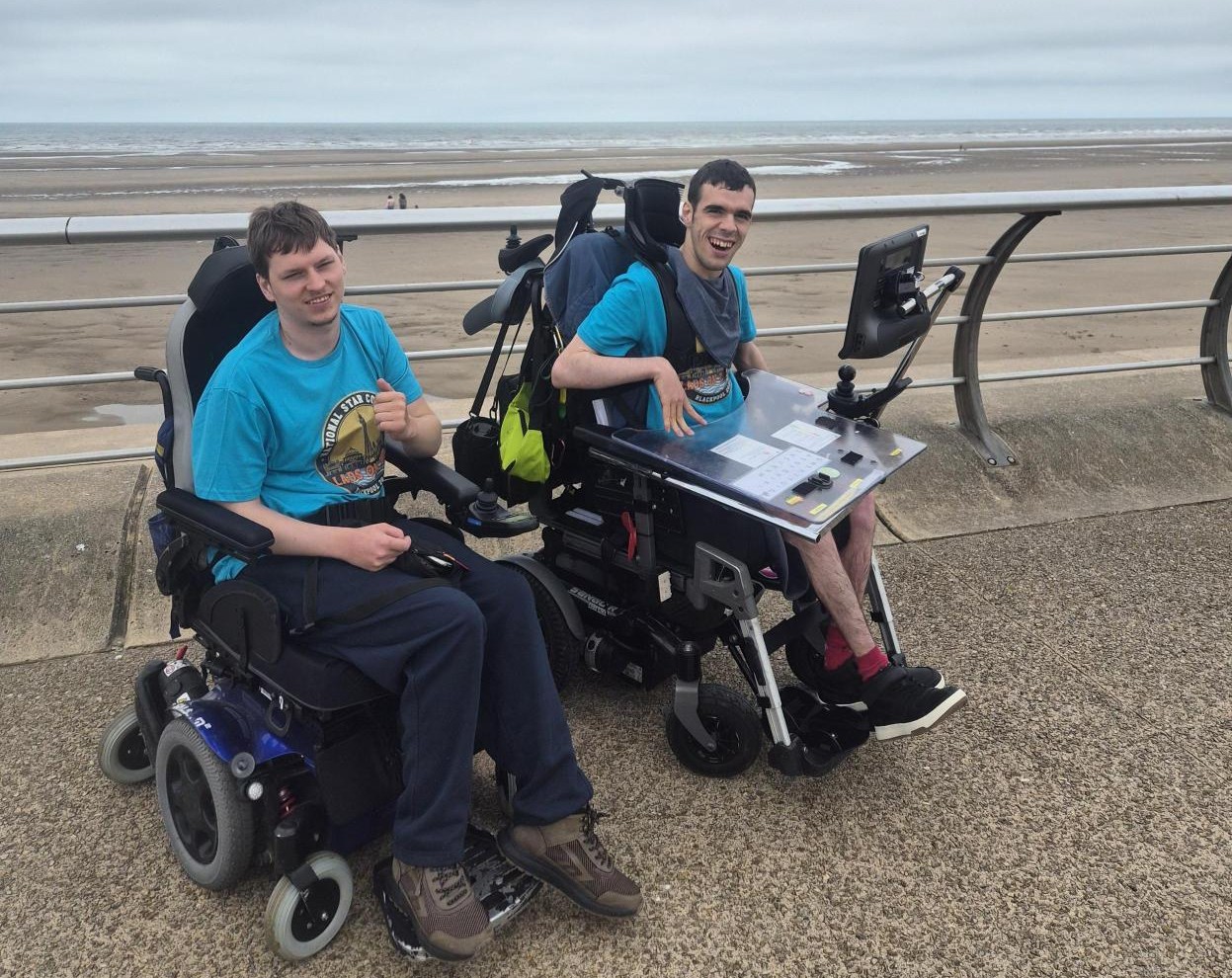 Two men in wheelchairs at the beach 