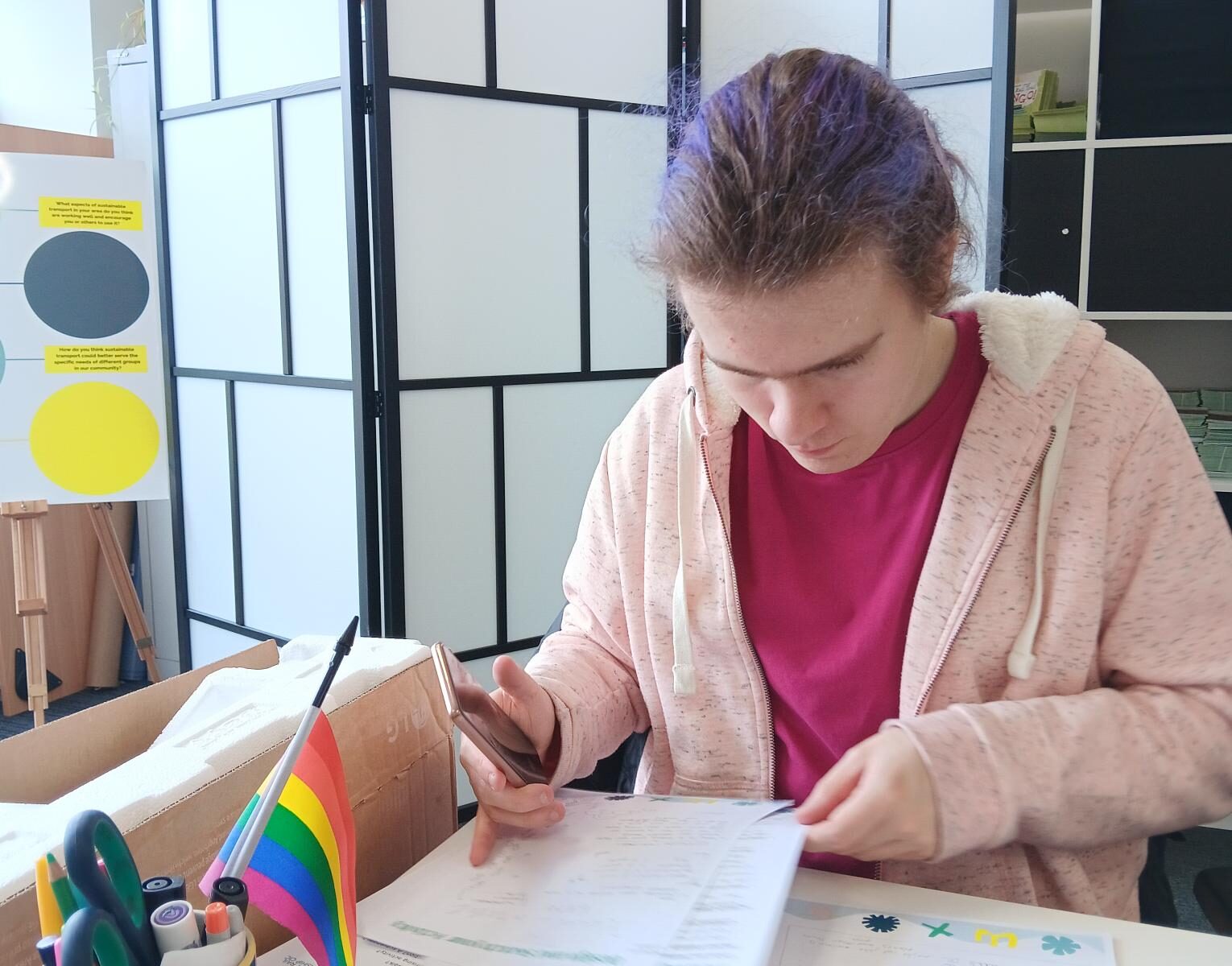 Student sat at a desk, looking at paperwork 