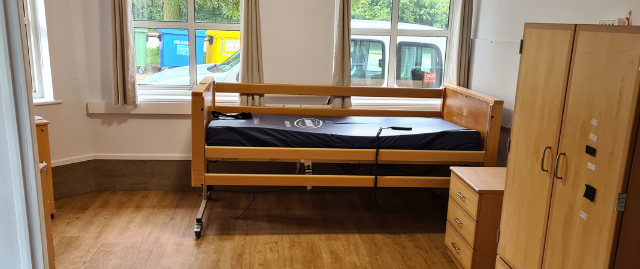 Accessible bedroom with bed wardrobe and drawers