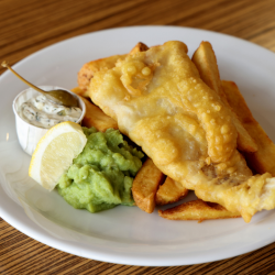 Plate of fish, chips, tartare sauce and mushy peas