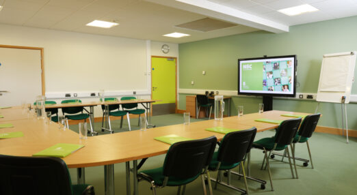 Anderson Room conference room layout with chairs tables and projector screen