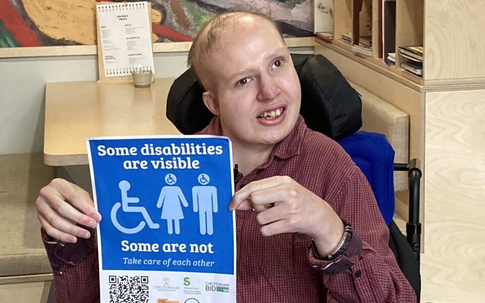 Sam proudly holding up his disability campaign sticker