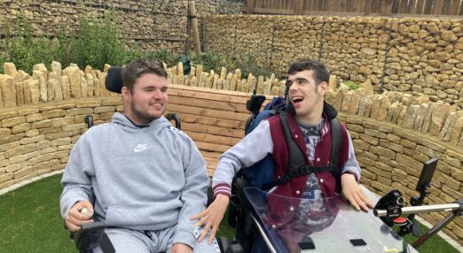 Residents smiling sat outside in the garden