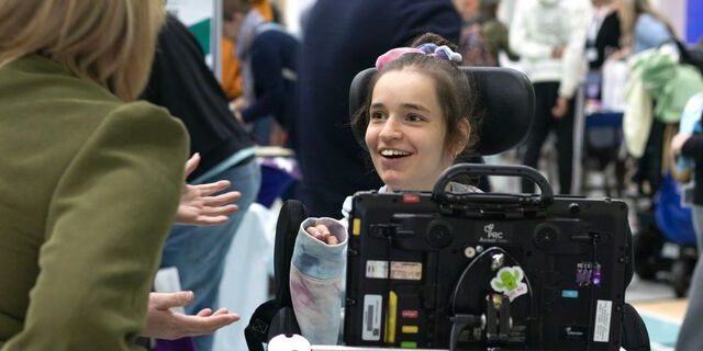 Student Ella smiling using her aac device