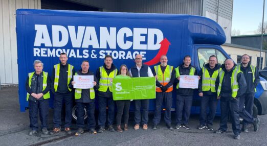 A group of staff from Advanced Removals standing in front of a removal van with a National Star fundraiser