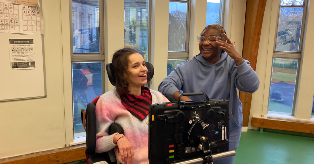 Ella smiling in a physio session with a member of the physio team