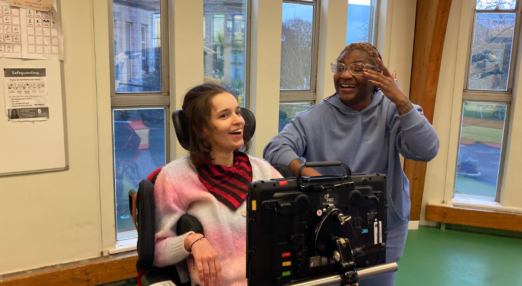 Ella smiling in a physio session with a member of the physio team