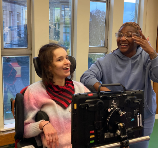 Ella smiling in a physio session with a member of the physio team