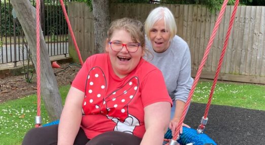 Ruth smiling with staff on swing