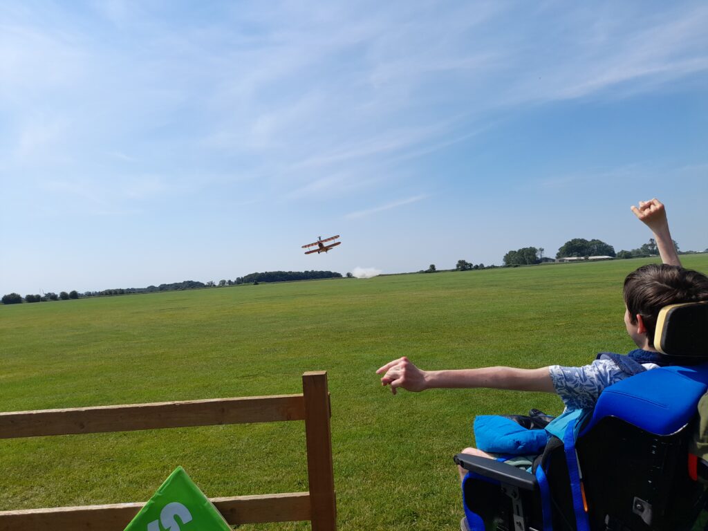 Student Justin cheering on a supporter taking part in the wing walk