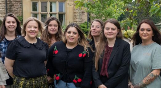 PBS team smiling outside of Ullenwood Manor