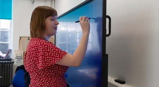 Tutor Jessica writing on whiteboard