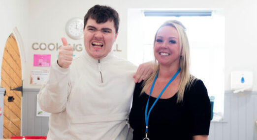 Student Evan and staff member Claire smiling in Shortwood