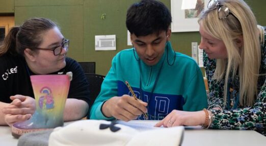Care and support workers helping student in session