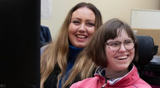 Kate smiling with support staff in work based learning session in StarPrint