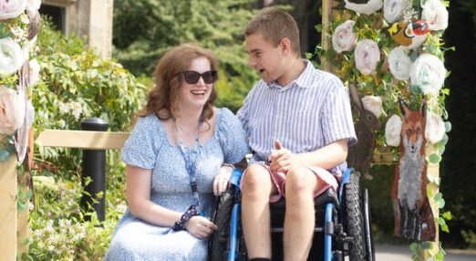 Max smiling with staff member at Ullenwood